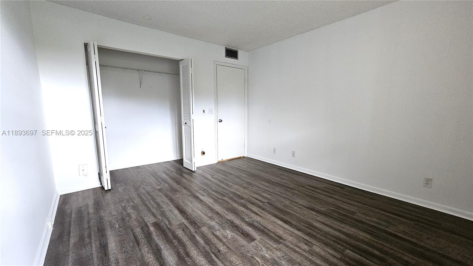 13450 Southwest 3rd Street, Unit 415D Pembroke Pines, FL 33027 - Photo 6 of 15 a view of empty room with wooden floor