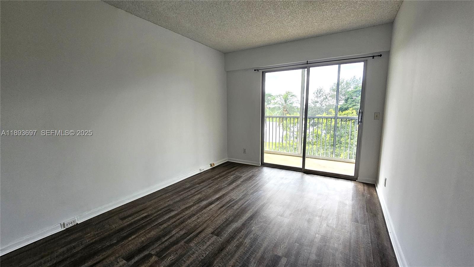 13450 Southwest 3rd Street, Unit 415D Pembroke Pines, FL 33027 - Photo 8 of 15 wooden floor in an empty room with a window