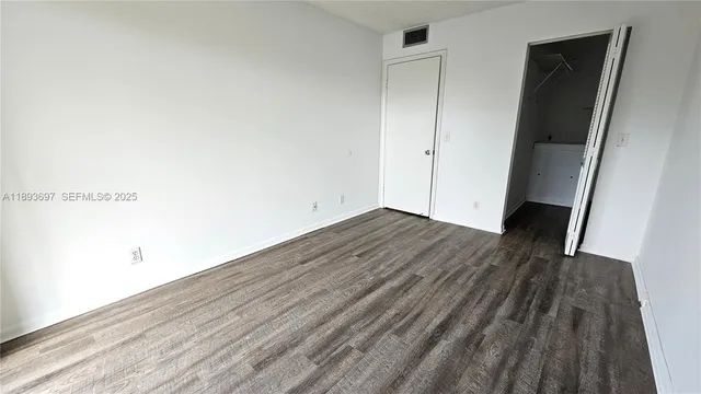 a view of hallway with wooden floor