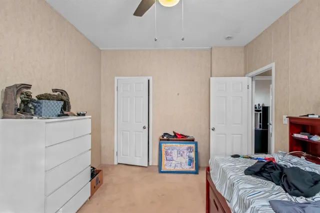 a bedroom with a bed and a dresser