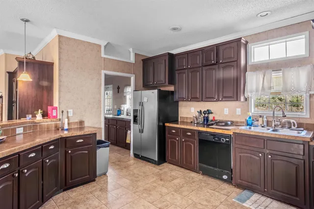 a kitchen with a sink stove and refrigerator