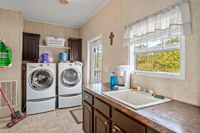 a utility room with sink dryer and washer