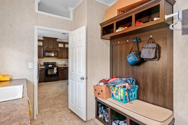 a living room with furniture and baby bed