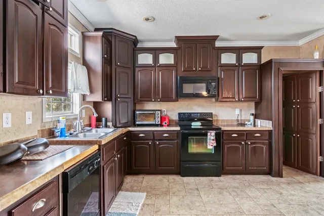 a kitchen with stainless steel appliances granite countertop a sink stove and cabinets