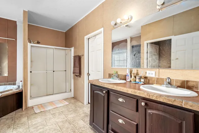a spacious bathroom with a granite countertop sink mirror and a