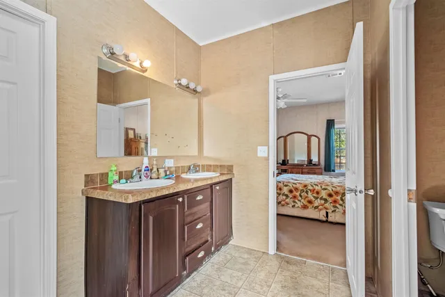 a en suite bathroom with a sink double vanity and mirror