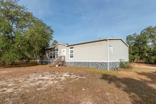 a backyard of a house with shaded area
