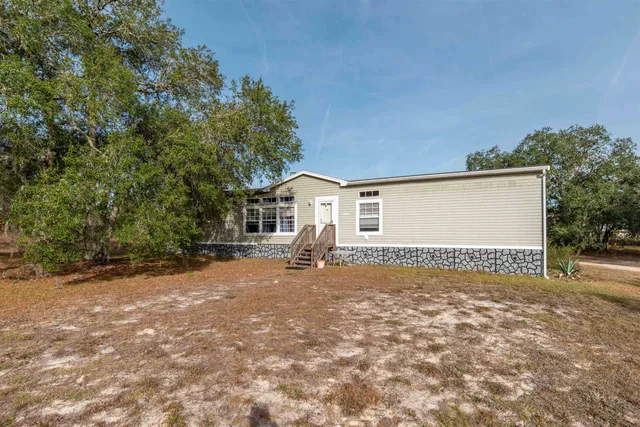 a view of a house with a yard and garage
