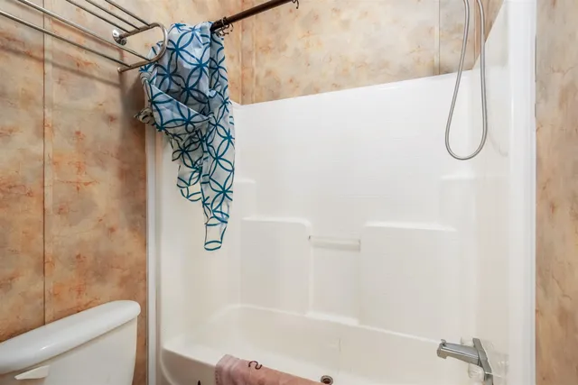 a bathroom with a shower curtain and a bathtub