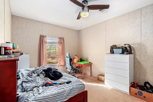 a bedroom with a bed and a window