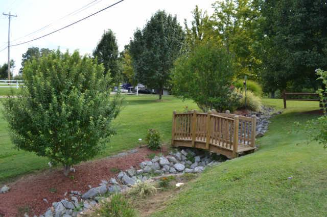 1890 Clydeton Road Waverly, TN 37185 - Photo 19 of 20 Bridge crossing rock ditch with landscaping