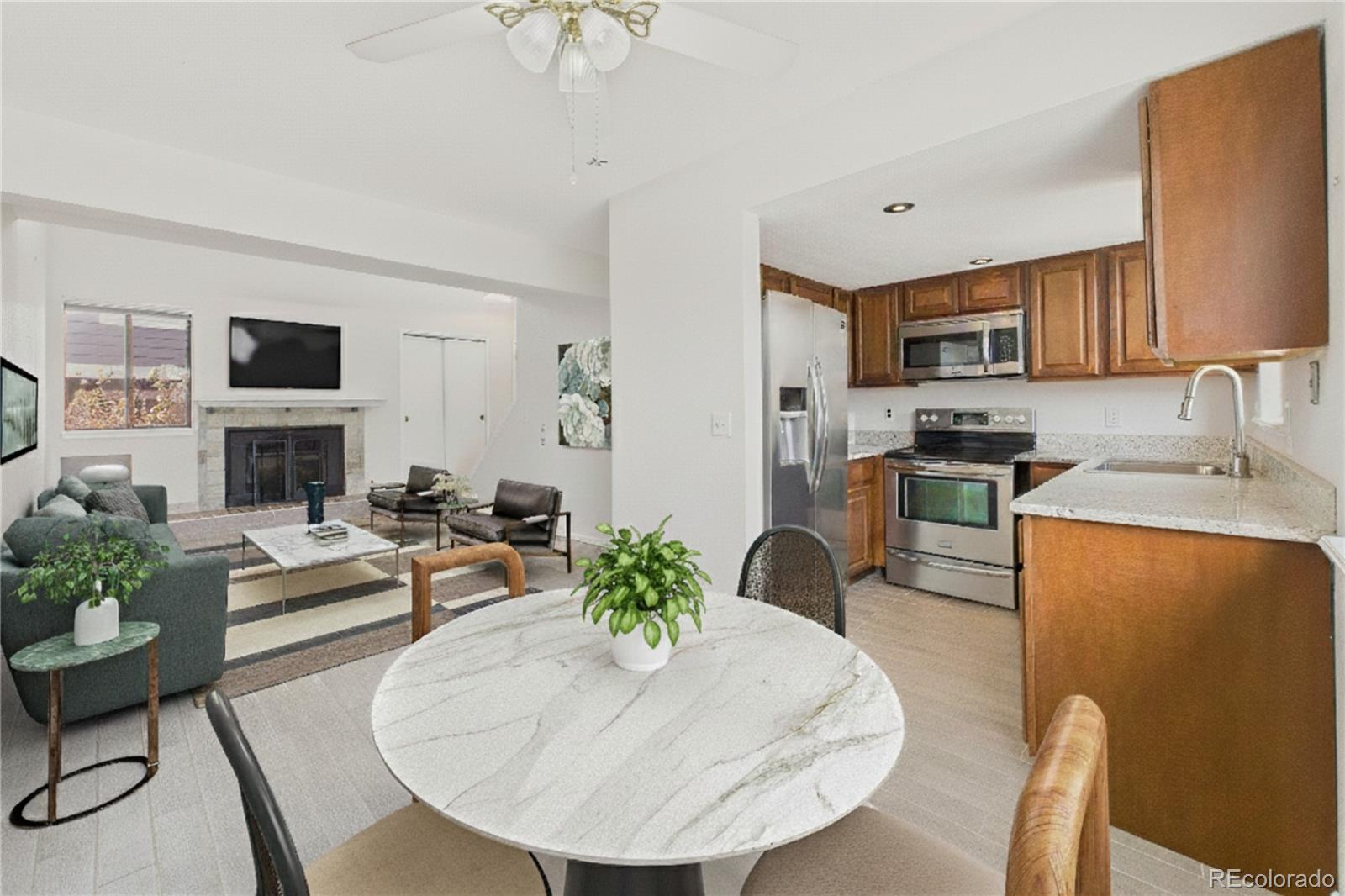 6725 West 84th Way, Unit 72 Arvada, CO 80003 - Photo 3 of 20 a living room with furniture a fireplace and a flat screen tv