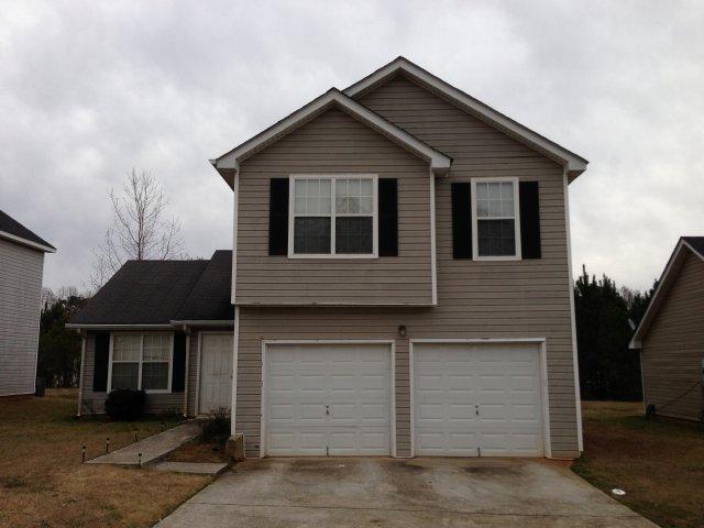 2912 Rambling Way Lithonia, GA 30058 - Photo 1 of 1 a front view of a house with a yard