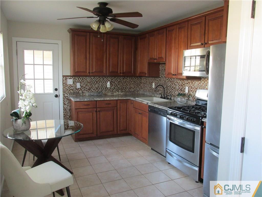 111 Winthrop Road Edison, NJ 08817 - Photo 3 of 10 a kitchen with stainless steel appliances granite countertop a stove a sink and a microwave