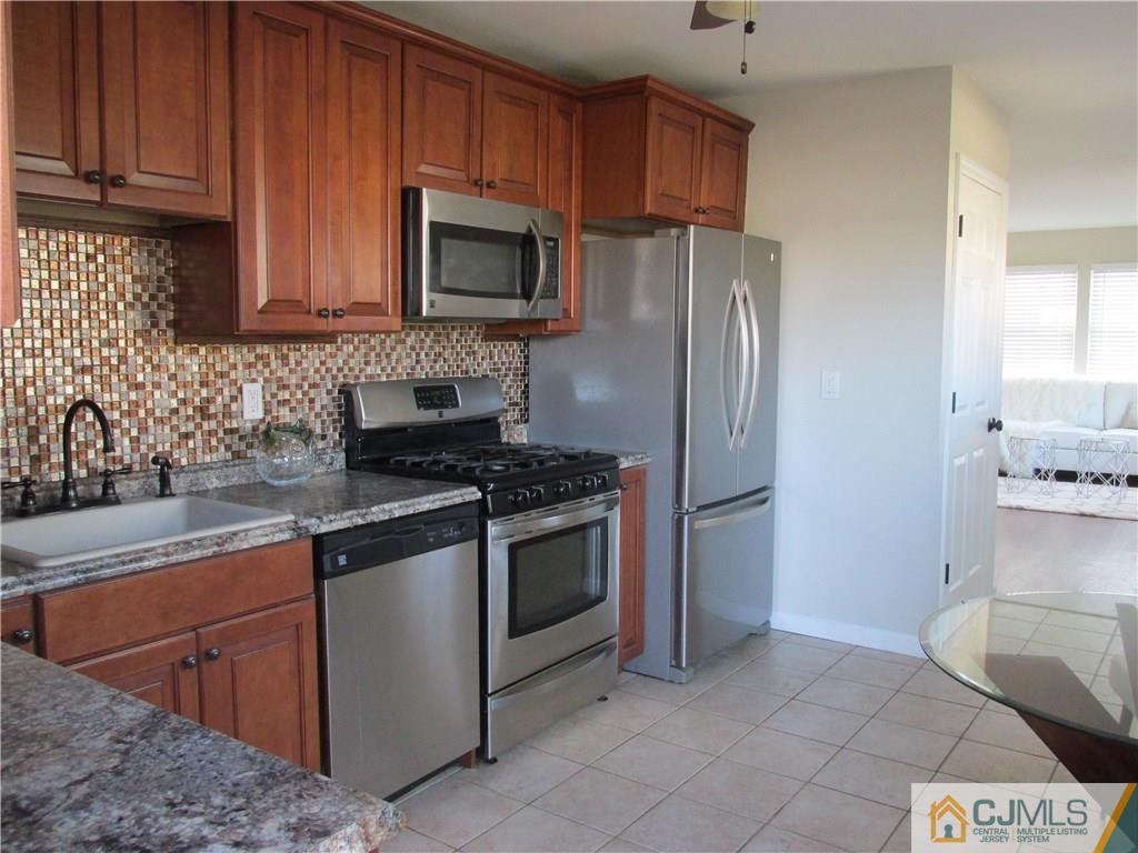 111 Winthrop Road Edison, NJ 08817 - Photo 4 of 10 a kitchen with stainless steel appliances granite countertop a refrigerator stove a sink and dishwasher