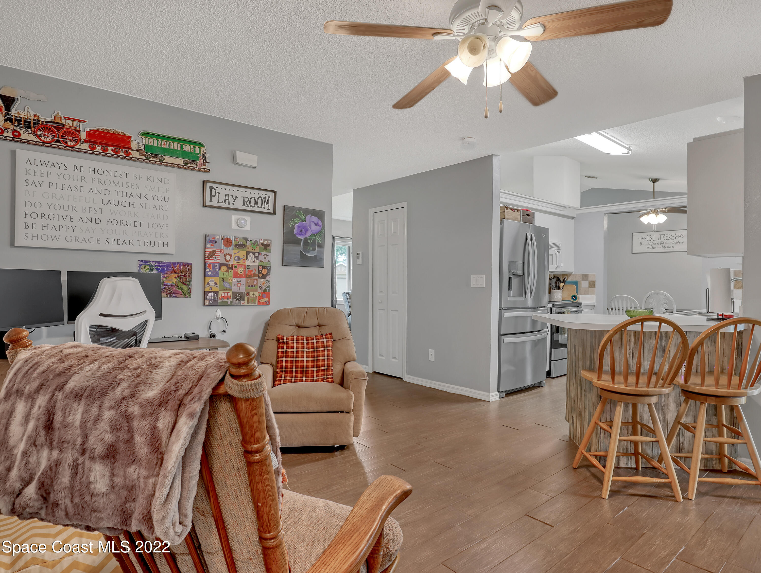 7010 Bayfront Road Cocoa, FL 32927 - Photo 11 of 36 a living room with furniture and a view of kitchen