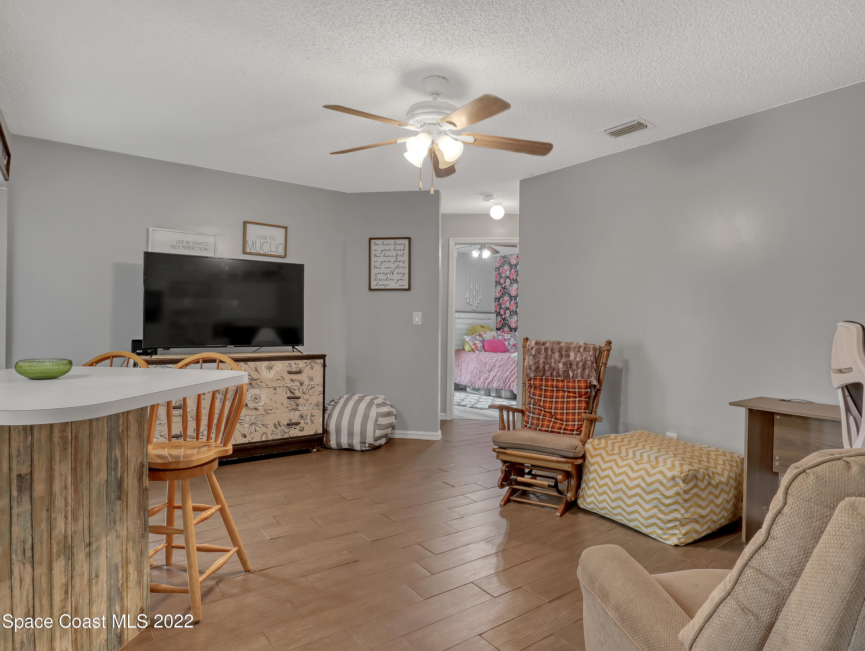7010 Bayfront Road Cocoa, FL 32927 - Photo 12 of 36 a living room with furniture and a flat screen tv