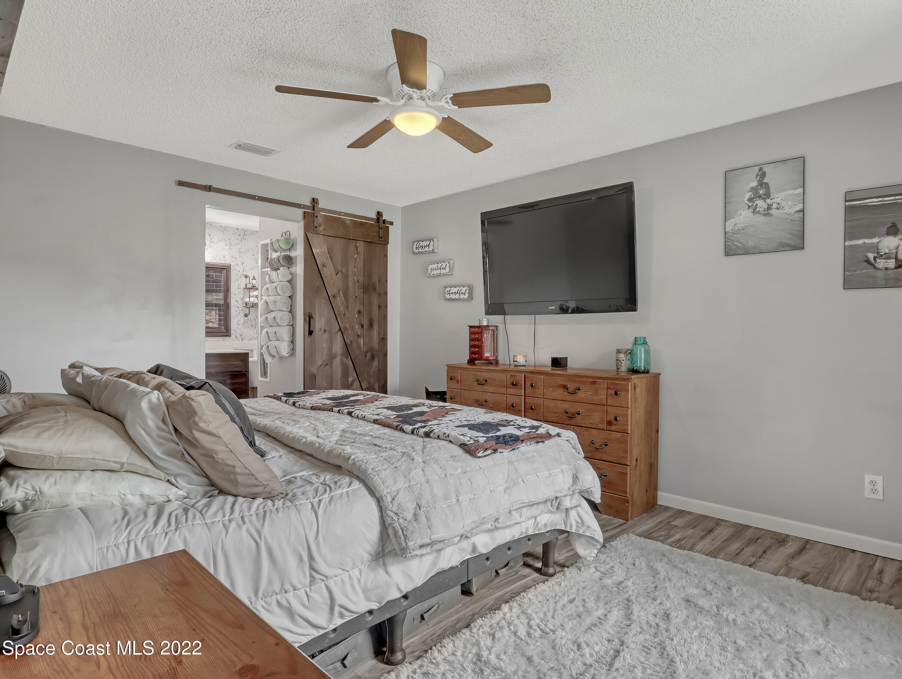7010 Bayfront Road Cocoa, FL 32927 - Photo 13 of 36 a bedroom with a bed and a flat screen tv