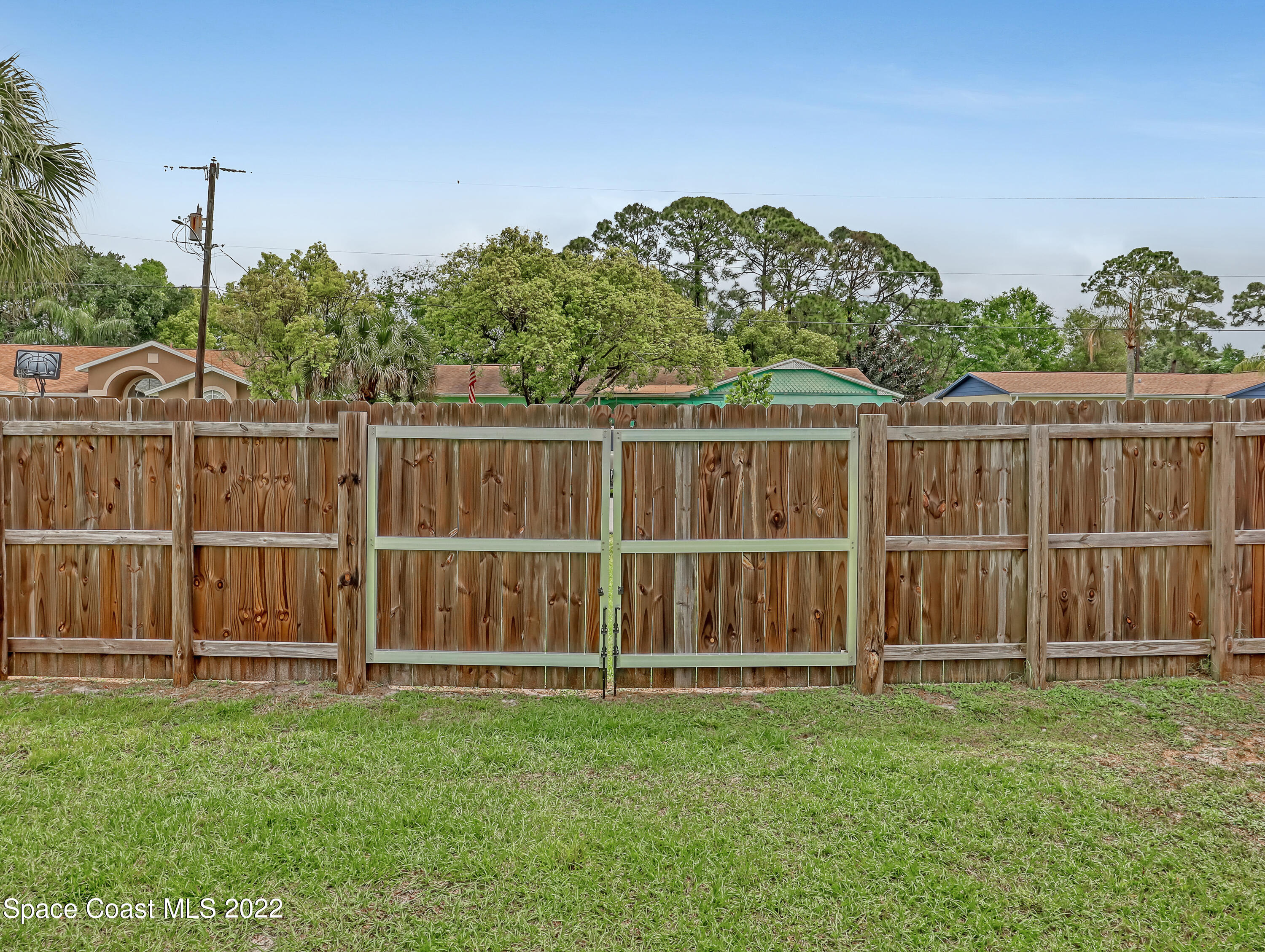 7010 Bayfront Road Cocoa, FL 32927 - Photo 32 of 36 a view of a yard with wooden fence
