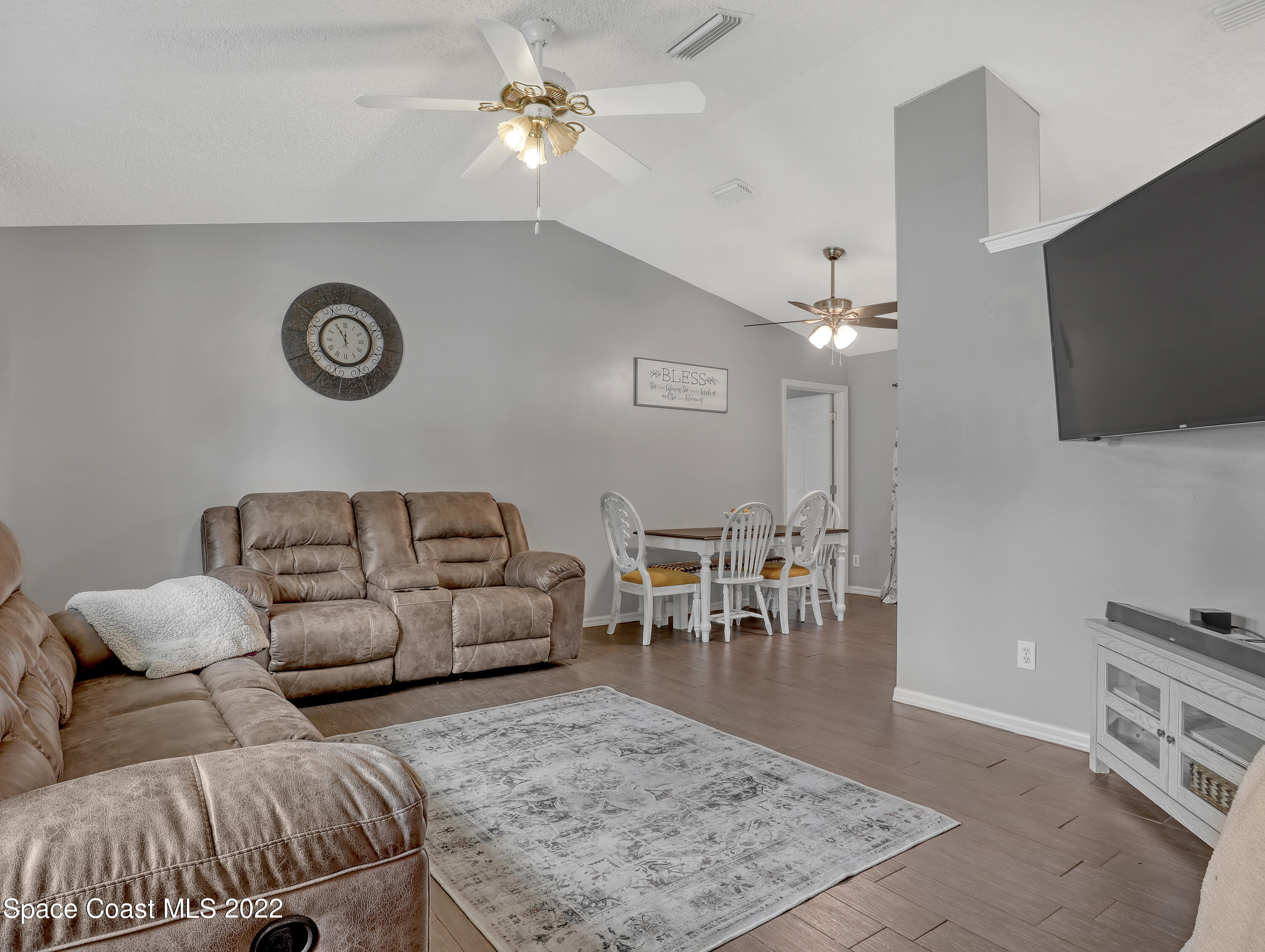 7010 Bayfront Road Cocoa, FL 32927 - Photo 5 of 36 a living room with furniture and a flat screen tv