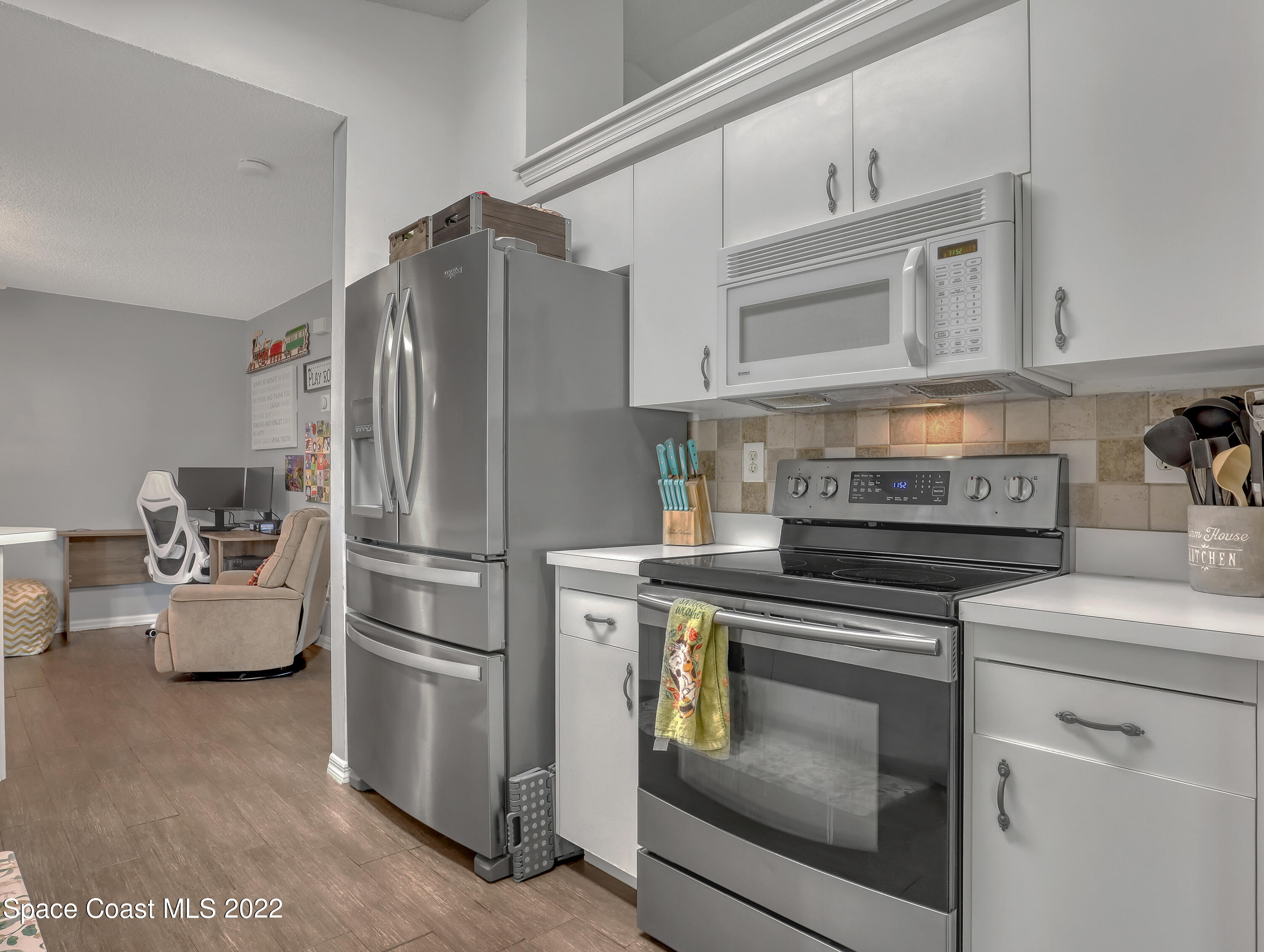 7010 Bayfront Road Cocoa, FL 32927 - Photo 8 of 36 a kitchen with stainless steel appliances white cabinets and a stove top oven