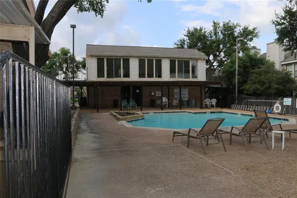 a view of a house with backyard porch and sitting area