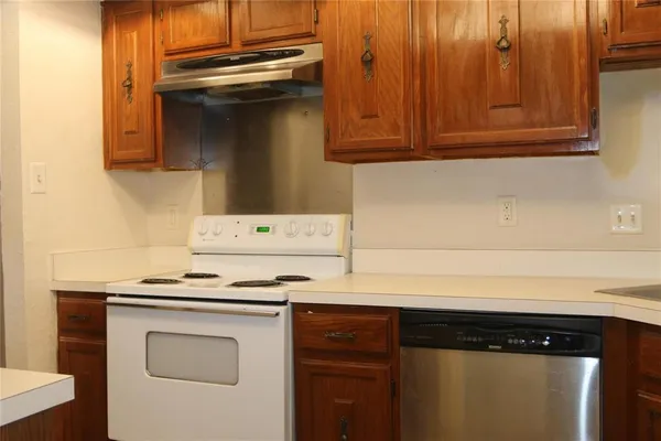 a stove top oven sitting inside of a kitchen