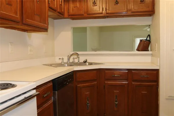 a sink with granite countertop cabinets and a sink