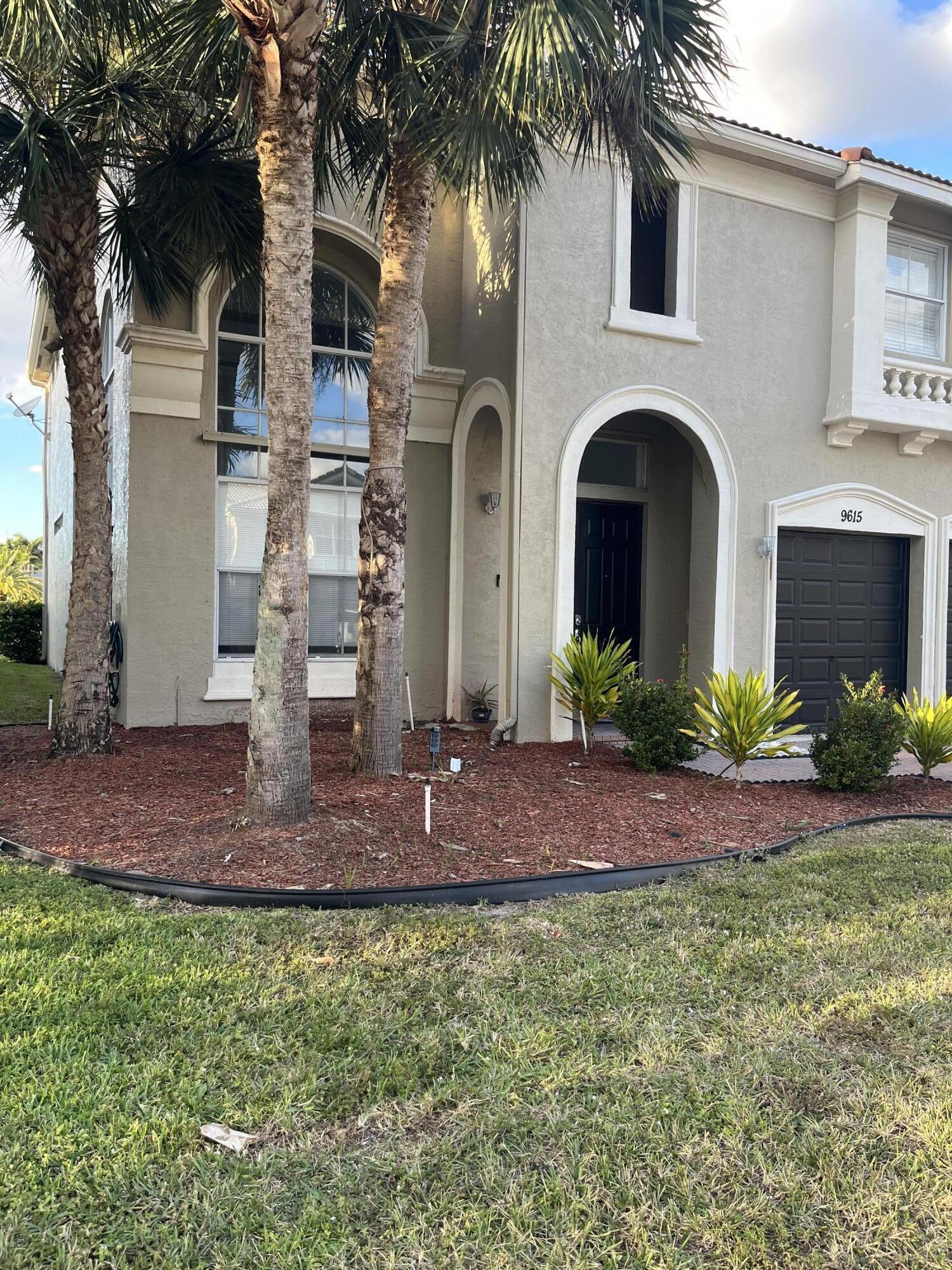 9615 Shepard Place Wellington, FL 33414 - Photo 2 of 46 a front view of a house with a yard