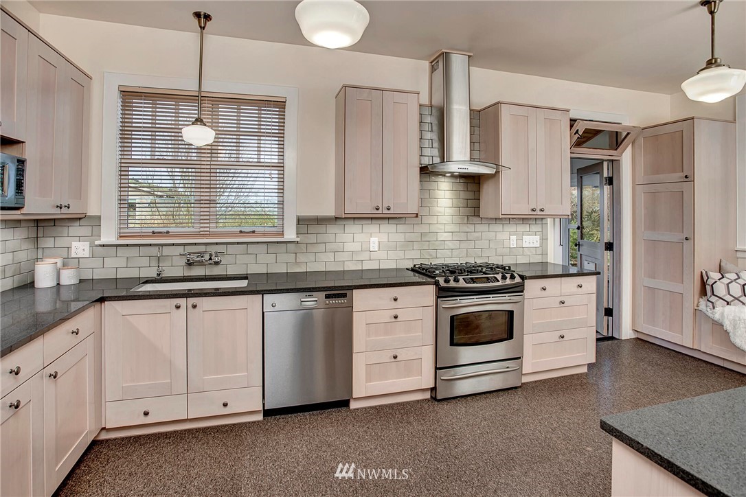 815 20th Avenue South Seattle, WA 98144 - Photo 13 of 33 a kitchen with white cabinets and white appliances