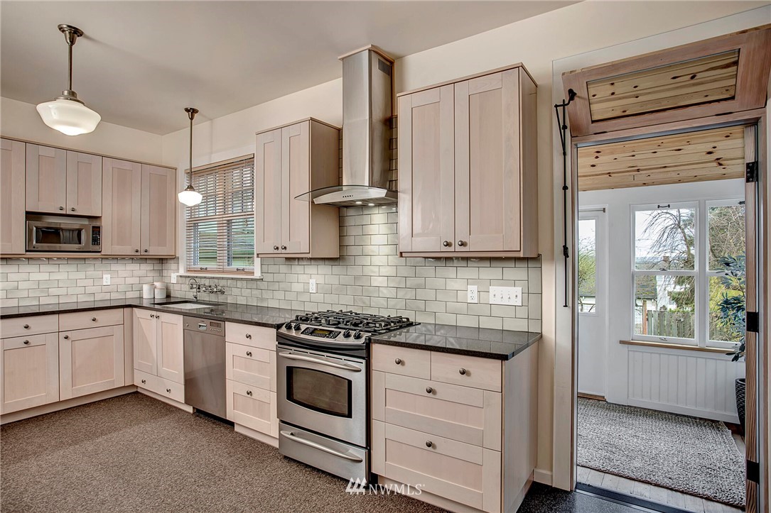 815 20th Avenue South Seattle, WA 98144 - Photo 14 of 33 a kitchen with white cabinets and white appliances