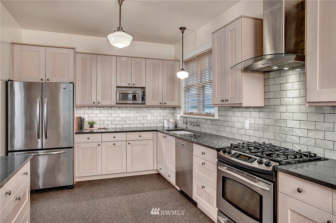 815 20th Avenue South Seattle, WA 98144 - Photo 15 of 33 a kitchen with stainless steel appliances granite countertop a stove a refrigerator and a microwave