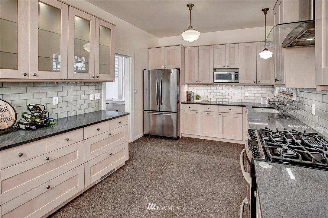 815 20th Avenue South Seattle, WA 98144 - Photo 16 of 33 a kitchen with stainless steel appliances granite countertop a sink stove and refrigerator