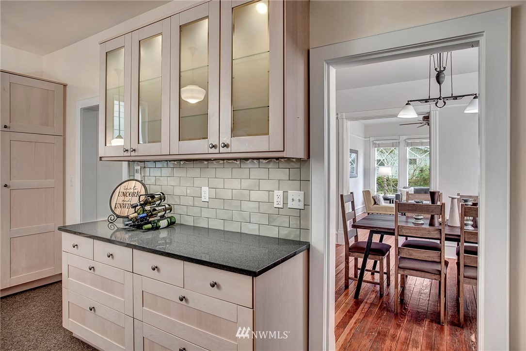 815 20th Avenue South Seattle, WA 98144 - Photo 17 of 33 a kitchen with granite countertop a table and chairs in it