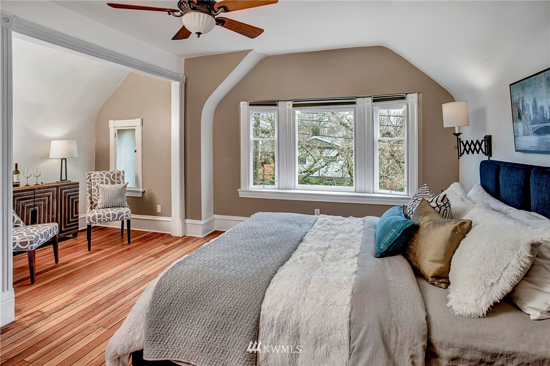 815 20th Avenue South Seattle, WA 98144 - Photo 22 of 33 a bedroom with a bed and a chandelier