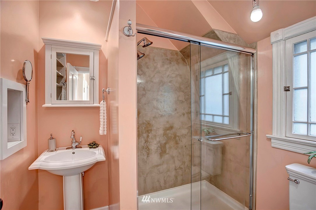 815 20th Avenue South Seattle, WA 98144 - Photo 25 of 33 a bathroom with a sink mirror and shower