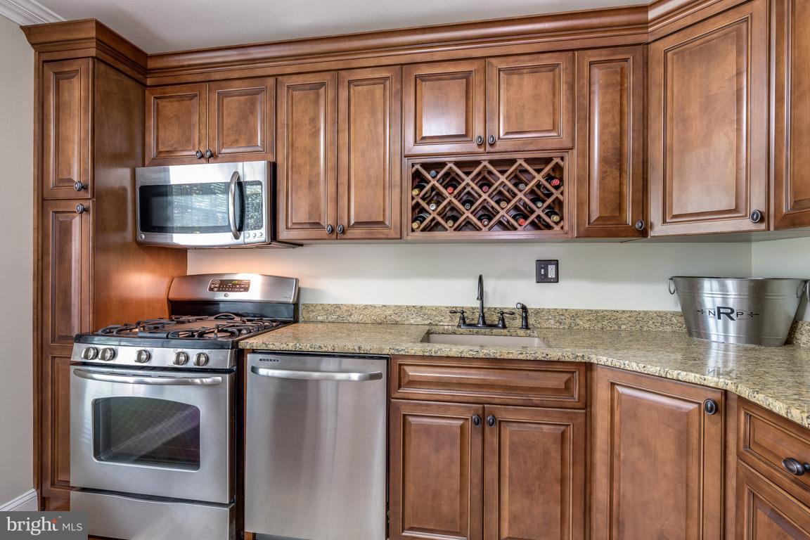 11841 Dunlop Court Reston, VA 20191 - Photo 16 of 30 a kitchen with granite countertop a stove a sink and a microwave
