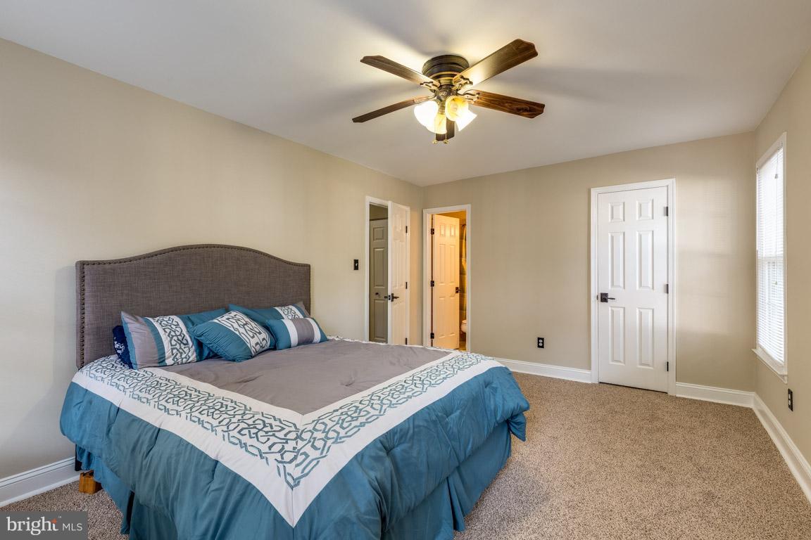 11841 Dunlop Court Reston, VA 20191 - Photo 25 of 30 a bedroom with a bed and a chandelier
