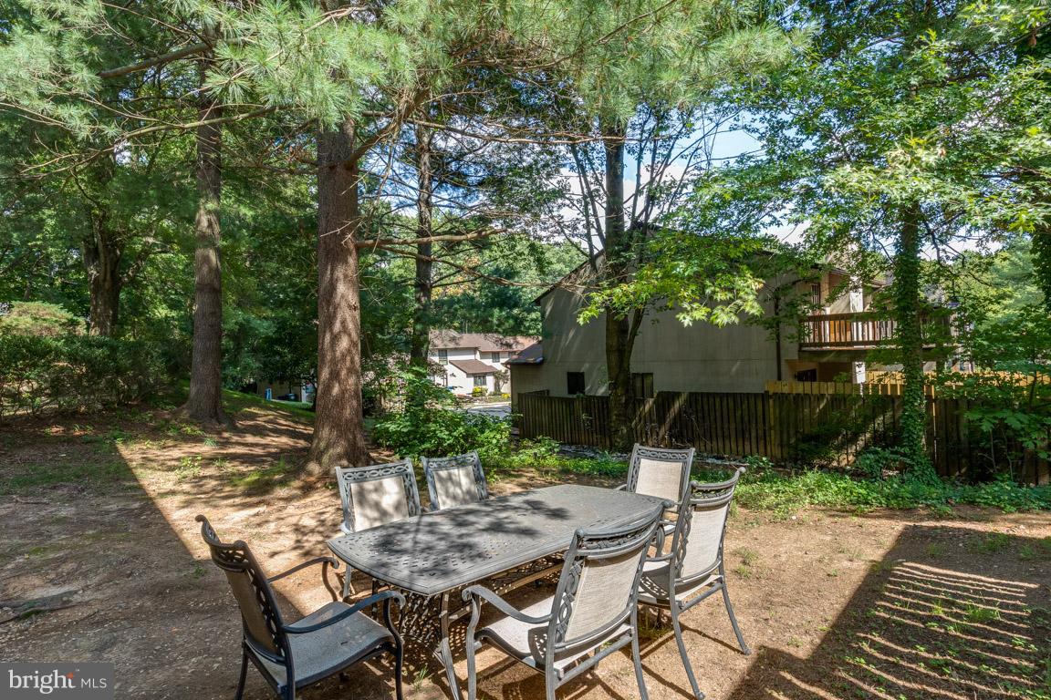 11841 Dunlop Court Reston, VA 20191 - Photo 4 of 30 a view of backyard with table and chairs and a barbeque