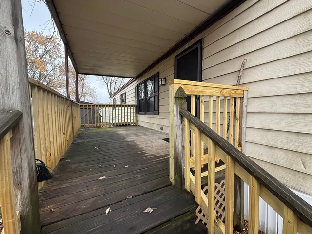 a view of deck with wooden floor and white walls