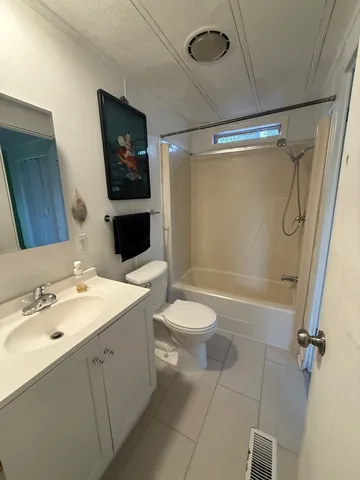 a bathroom with a toilet sink shower and mirror