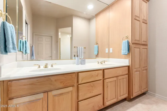 a bathroom with a double vanity sink and a mirror