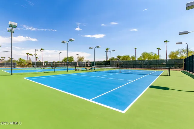 a small pool with lawn chairs in front of it