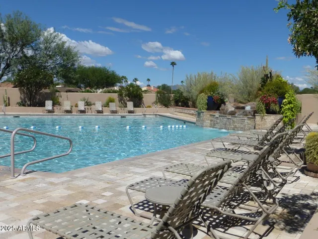 a view of a patio with a table and chairs under an umbrella