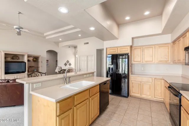 a kitchen with a sink appliances and cabinets