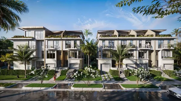 a front view of multiple houses with yard