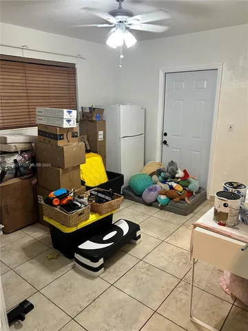 a dining room with furniture and kitchen view