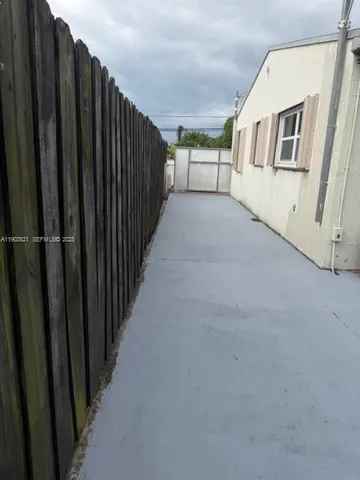 a view of a house with wooden fence