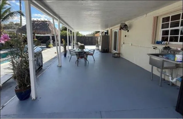 a lobby with furniture and potted plants