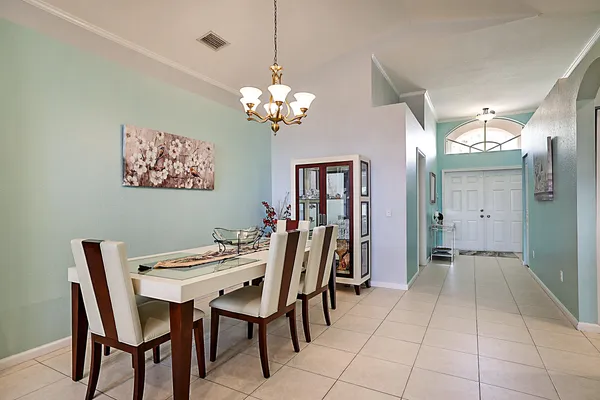 a view of a dining room with furniture and chandelier